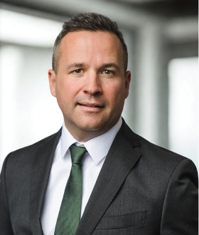 professional-businessman-portrait-in-dark-suit-and-green-tie